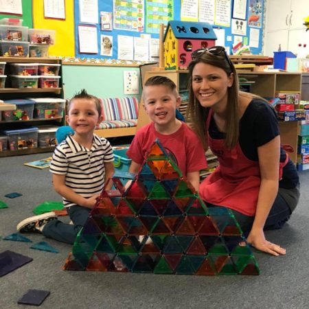 Kids and teacher building a magnetic tile pyramid at John Knox Co-op Preschool