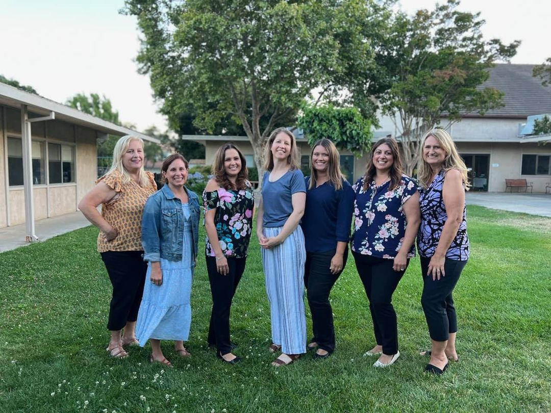 John Knox Co-op Preschool teaching staff standing together outdoors